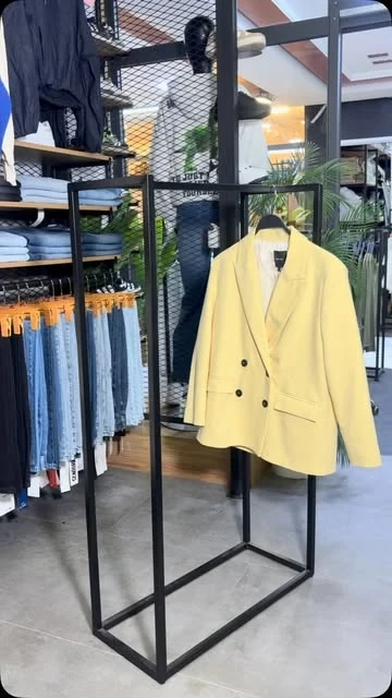 Blazer jaune sur un portant de la boutique
